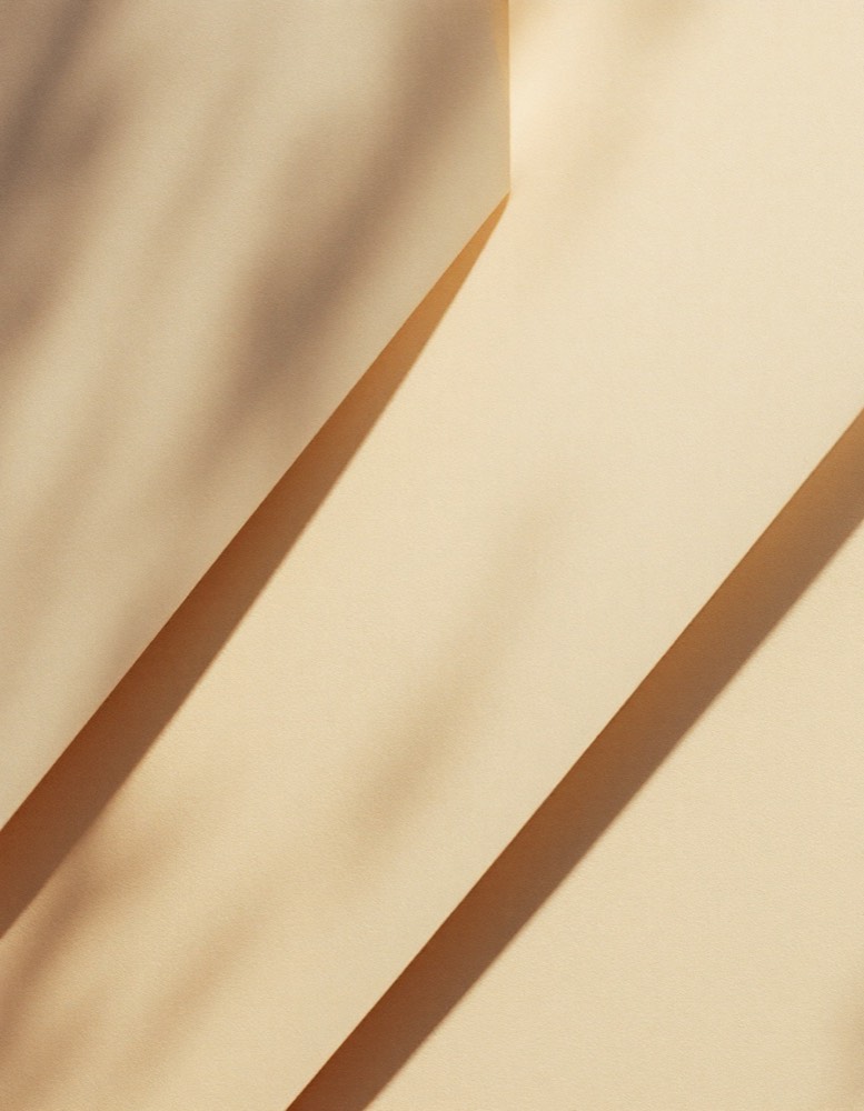 A sheet of warm writing paper under a low lamp