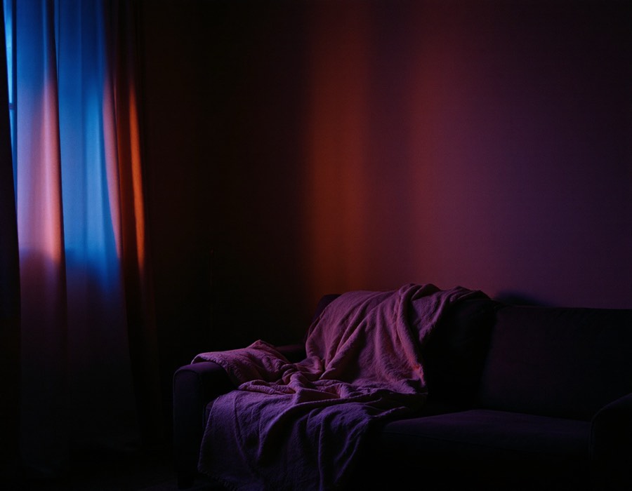 A dim room lit by a screen, ready for a film